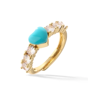 Golden heart ring with turquoise enamel and zircon stones on a white background