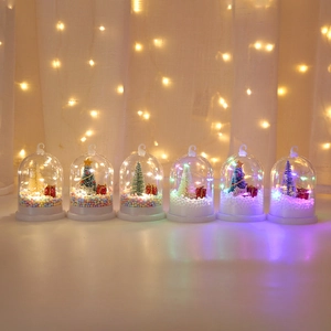 Close-up of a 6-piece set of lighted Christmas domes with colorful miniature trees