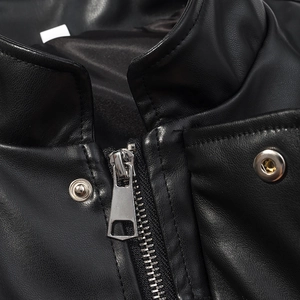 Detail of stand collar, smooth metal zipper, and snap buttons on black faux leather jacket