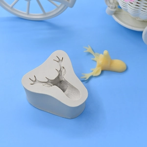Christmas deer head silicone mold for DIY baking and cake decorating on blue background