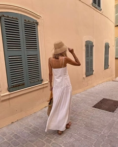 Detail view of white pleated tiered maxi dress with thin straps for summer vacations