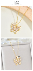 Detailed close-up of gold butterfly pendant featuring sparkling marquise zircon crystals