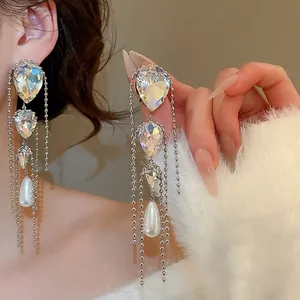 Silver needle drop earrings with crystal fringe and elegant white teardrop pearl