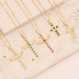 Golden stainless steel cross necklaces with colorful zircon stones on marble