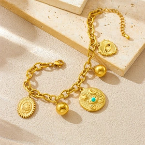 Gold chunky chain bracelet with sun medallion, evil eye turquoise and polished gold charms