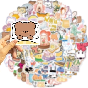 Close-up of cute cartoon bear stickers held in hand with soft bokeh background