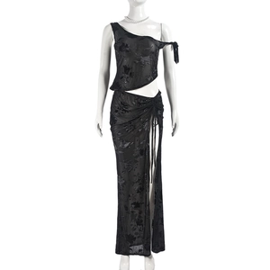 Detail of sheer black lace mesh fabric and high slit on a two-piece skirt set