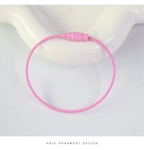 Detailed macro view of pink coated stainless steel wire key ring with knurled screw connector