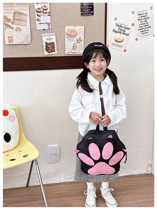Cute black cat paw backpack for kids with pink pads shown in a lifestyle scene