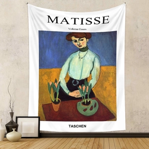 Artistic detail of Matisse style tapestry on grey wall with minimalist home decor