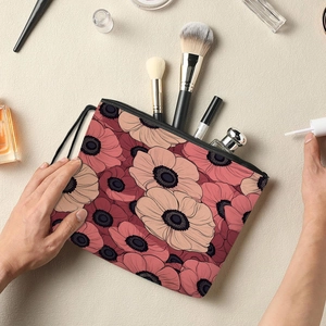 Handheld floral cosmetic bag with red anemone patterns and black zipper strap