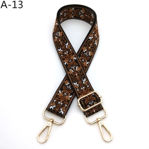 Detail of adjustable guitar-style strap featuring ethnic jacquard weave and gold hardware