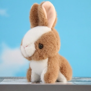 Close-up of soft plush rabbit keychain featuring long ears and brown-white fluffy texture