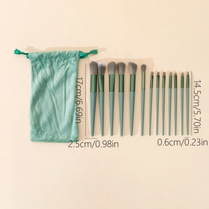 Detail view of 13-piece green makeup brush set with velvet bag and size dimensions