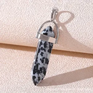 Macro shot of Dalmatian Jasper bullet point pendant with polished silver metal bail