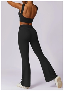 Rear view of black yoga vest and high-waisted flared leggings showing fabric texture