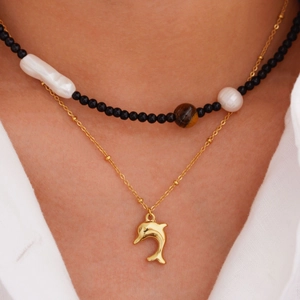 Layered gold necklace featuring sea dolphin pendant, black onyx beads and natural pearls