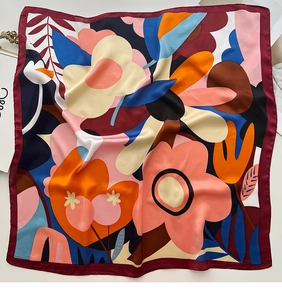 Detailed top view of large square silk scarf featuring bold abstract floral patterns