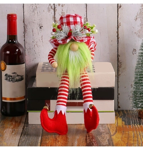 Detail of Christmas gnome with green beard, plaid hat, and long striped legs for decor