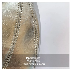 Detail of silver metallic leather handbag with reinforced stitching and crumpled texture