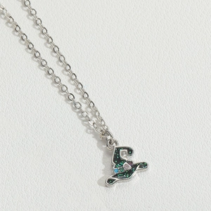 Detail of silver wizard hat pendant with green glitter and small purple blue gemstones
