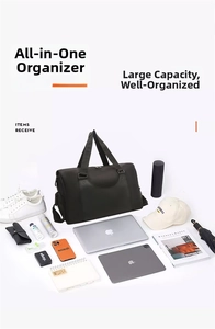 Flat lay of black waterproof fitness bag with organized travel items and accessories