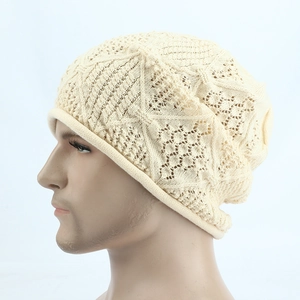 Detailed close-up of hollow knit beige slouchy beanie with intricate geometric patterns