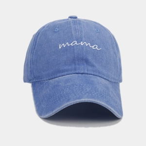 Close-up of white mama script embroidery on blue washed cotton vintage baseball cap