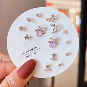 Detail of Korean-style mixed earrings set featuring bow, pearl, and zircon designs
