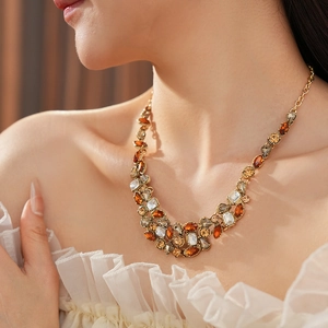 Close-up of vintage palace style necklace featuring multi-colored crystals and gold-tone base