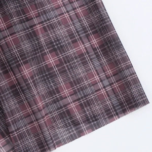 Close-up of the dark red and grey plaid fabric texture for the backless maxi dress