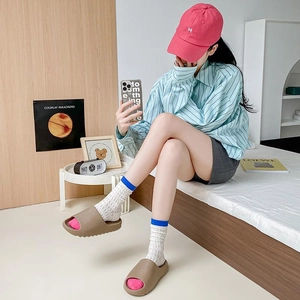 Summer mesh mid-calf socks in white and blue worn with stylish EVA platform slippers