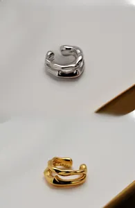 Macro detail of S925 sterling silver ear cuffs with irregular lava texture and double layers