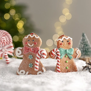 Charming gingerbread man Christmas tree ornaments on white snow with festive bokeh background