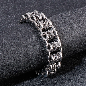 Detailed view of heavy industrial stainless steel link bracelet with dragon carvings