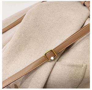 Close-up of adjustable leather shoulder strap with premium golden metal buckle detail