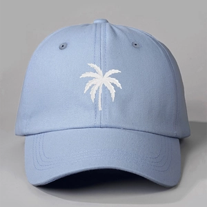 Detailed view of white palm tree embroidery on light blue twill cotton baseball cap