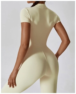 Detail of cream yoga bodysuit featuring ergonomic back stitching and compression fabric