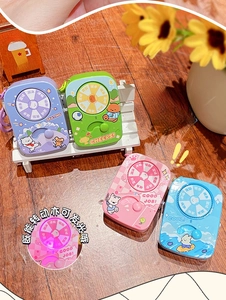 Detail of four colorful glowing spinner keychains with cartoon sports graphics