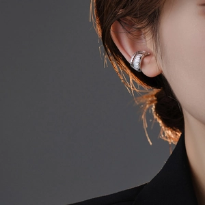 Detail of silver crescent ear bone cuff with multiple rows of sparkling zircon stones