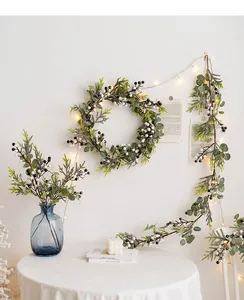 Detail of Christmas wreath and vine with eucalyptus leaves, berries and warm LED lights