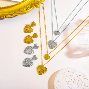 Textured double heart necklace and earrings set in gold and silver finish