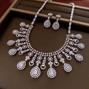 Elegant silver necklace and drop earrings set with shimmering zircon crystals