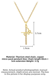 Macro view of gold cross pendant with clear cubic zirconia and steel chain details