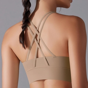 Detail view of khaki sports bra featuring criss-cross back straps and wide support band