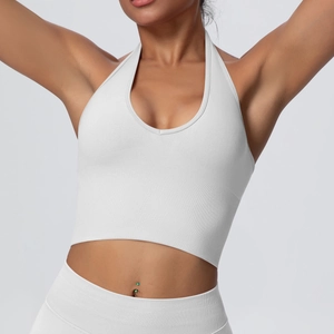 Detail of white ribbed halter yoga bra with deep V-neckline and seamless fabric texture