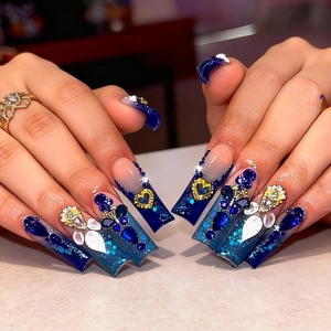 Starry blue gradient press-on nails with luxury rhinestones and gold heart charms