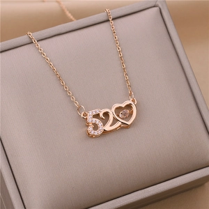 Detail of rose gold 520 necklace with hollow heart pendant and sparkling gemstone
