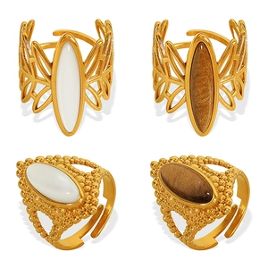 Set of gold open rings with large oval white and brown gemstones in hollow leaf design