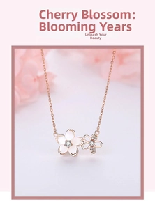Detailed macro view of rose gold cherry blossom necklace with white shell and crystals